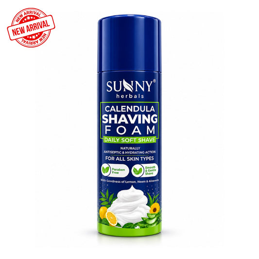 A can of Sunny Herbals Calendula Shaving Foam on a white background, featuring a blue cap and a dark blue label with green and yellow accents, a red 'New Arrival' stamp in the top-left corner, and a graphic of shaving foam at the bottom.
